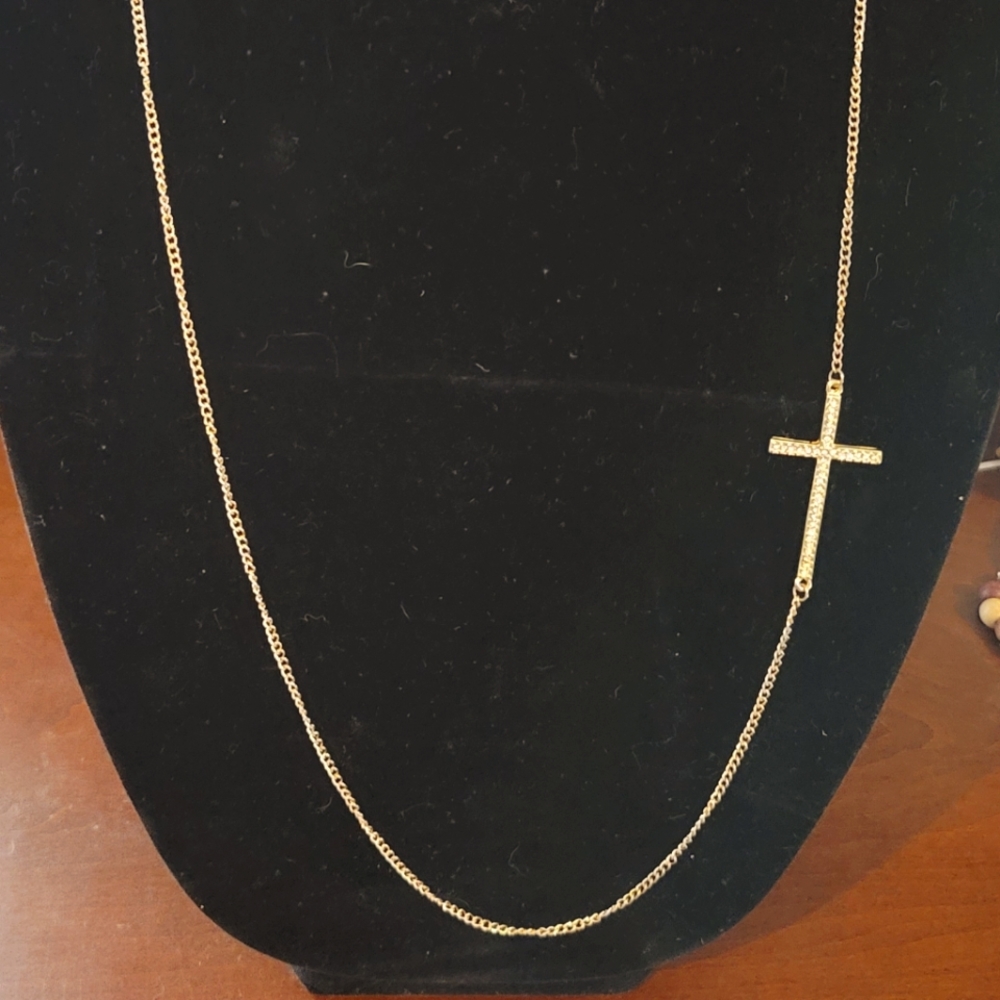 Cross attached to 23 in. gold chain.